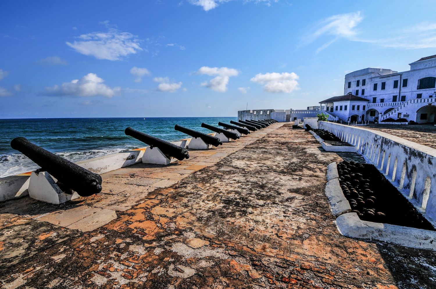 Old cannons along the shoreline at Cape Coast Castle